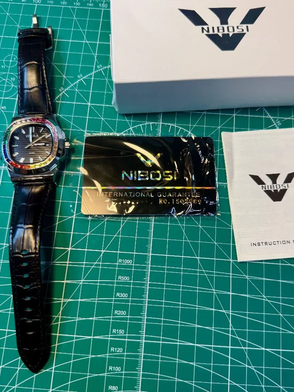 Onola quartz men's watch silver and black leather strap. Rainbow Gems Bezel.
